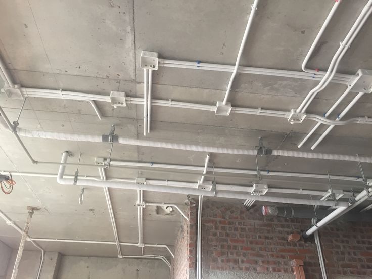 Electricians inspecting heavy duty conduits on site